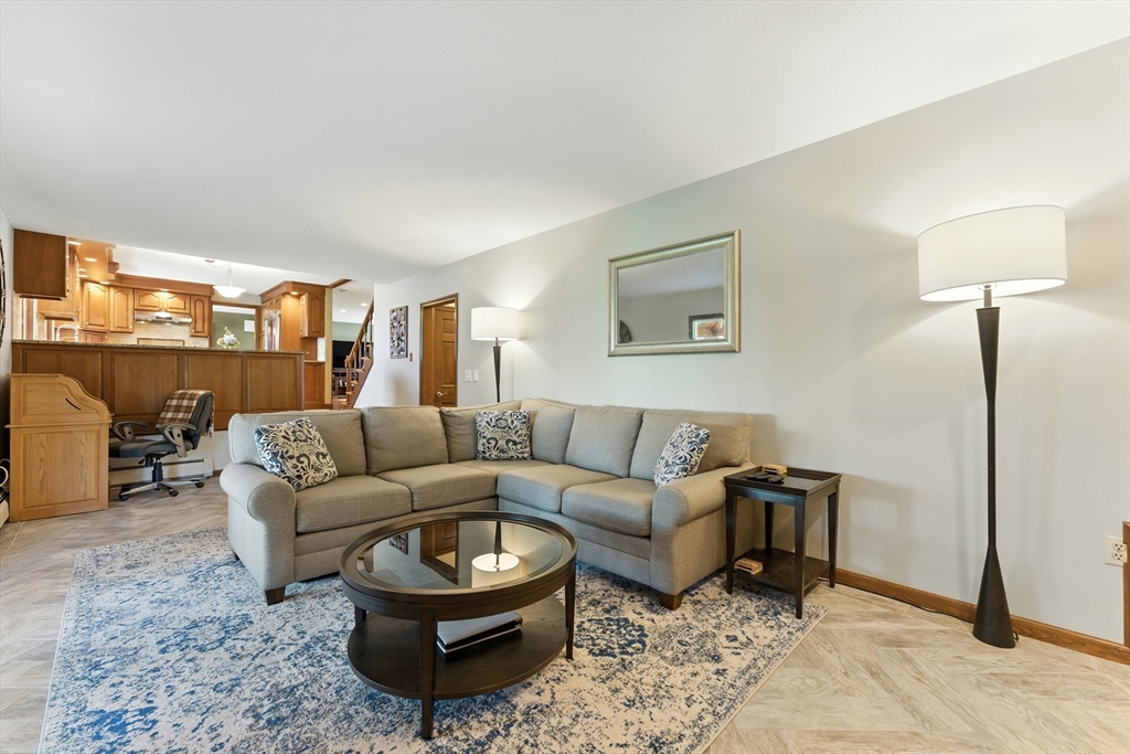 51 Newcrest Street Ludlow, MA 01056 - Photo 35 of 38 a living room with furniture a rug and painting on the wall