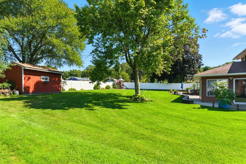 51 Newcrest Street Ludlow, MA 01056 - Photo 6 of 38 a view of a house with a backyard porch and sitting area