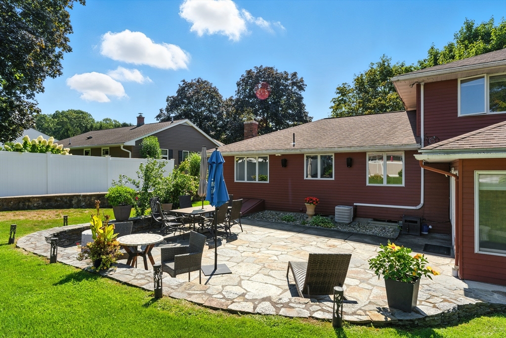 51 Newcrest Street Ludlow, MA 01056 - Photo 9 of 38 a view of a house with backyard sitting area and garden
