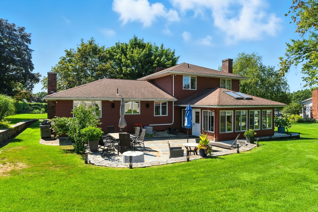 51 Newcrest Street Ludlow, MA 01056 - Photo 10 of 38 a front view of a house with garden and sitting area
