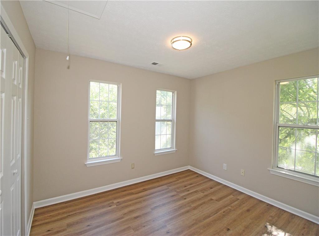 1334 Ambercrest Way Austell, GA 30168 - Photo 16 of 20 an empty room with wooden floor and windows