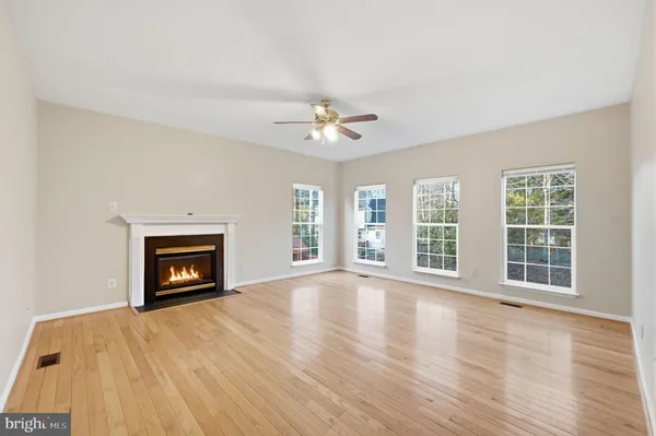 a view of an empty room with a fireplace and a window