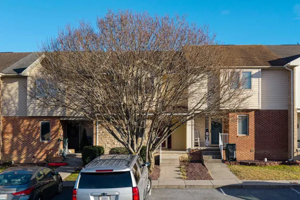 a kitchen with stainless steel appliances granite countertop a refrigerator a stove top oven a sink and dishwasher