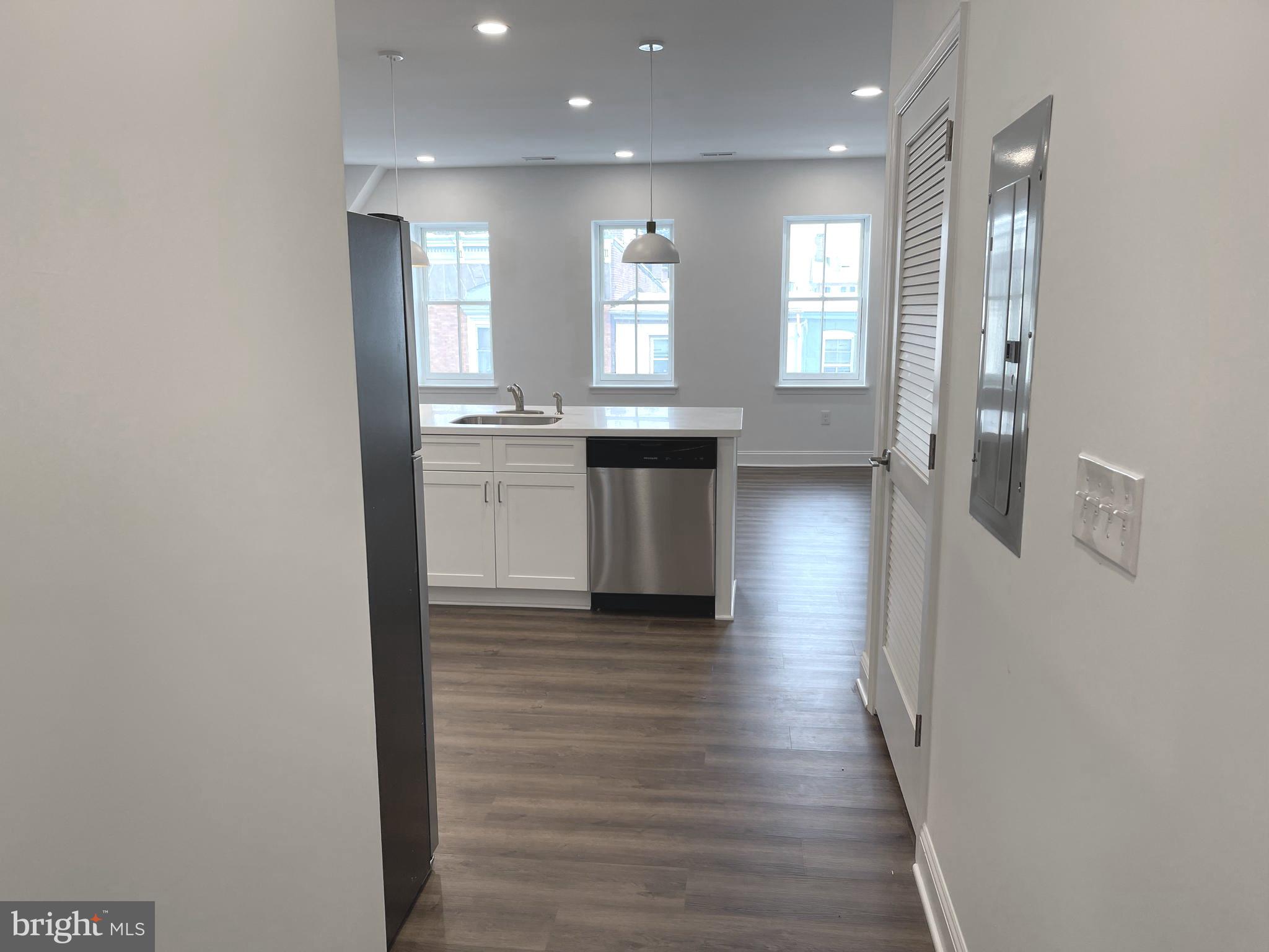 26 South State Street Newtown, PA 18940 - Photo 14 of 20 a view of a kitchen with a sink and dishwasher a refrigerator with wooden floor
