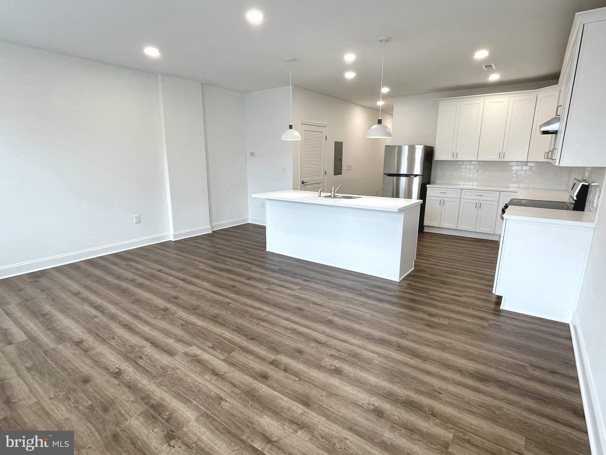 26 South State Street Newtown, PA 18940 - Photo 19 of 20 a view of kitchen with kitchen island wooden floor stainless steel appliances and cabinets