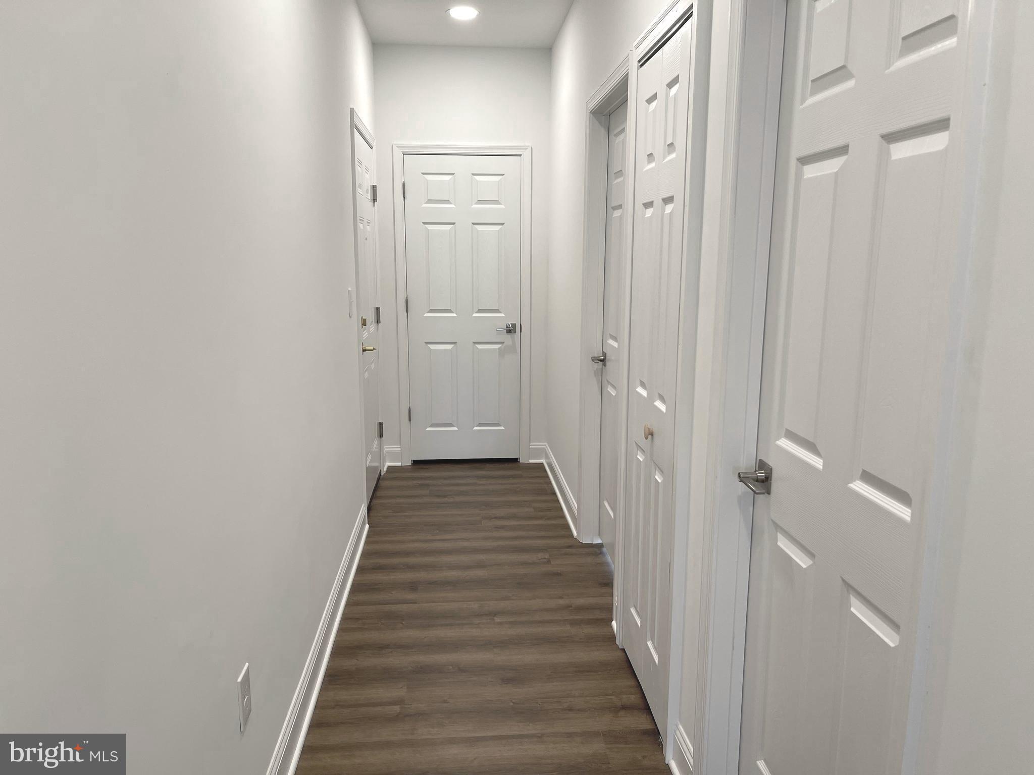 26 South State Street Newtown, PA 18940 - Photo 2 of 20 a view of a hallway with wooden floor and staircase