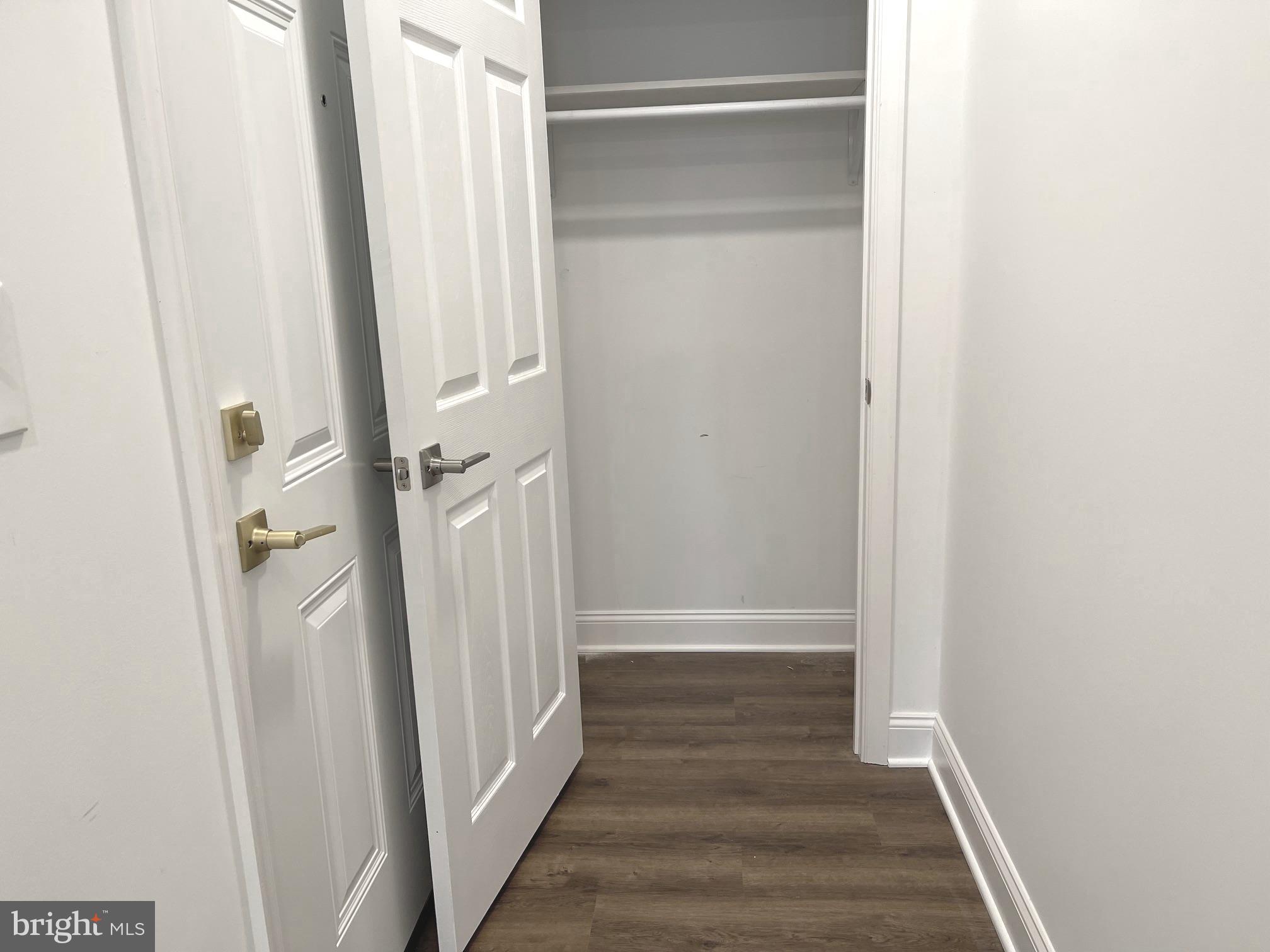 26 South State Street Newtown, PA 18940 - Photo 3 of 20 a view of a hallway with wooden floor and staircase
