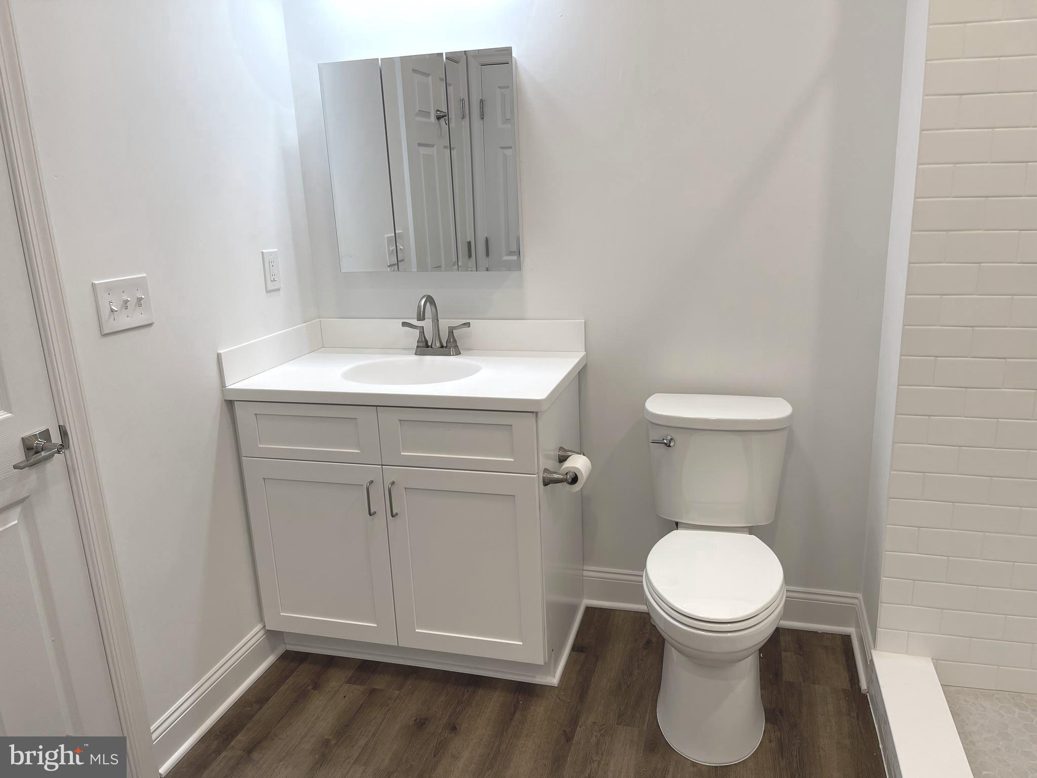 26 South State Street Newtown, PA 18940 - Photo 10 of 20 a white toilet sitting next to a bathroom sink