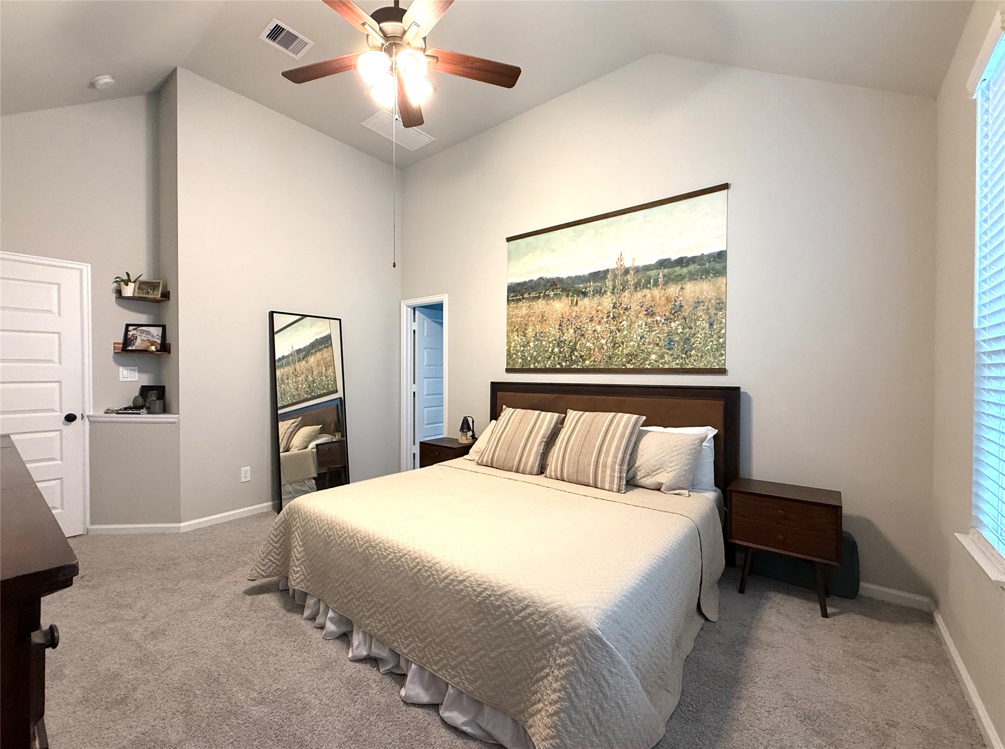 5614 Green Rise Lane Houston, TX 77091 - Photo 12 of 27 a bedroom with a large bed and a chandelier