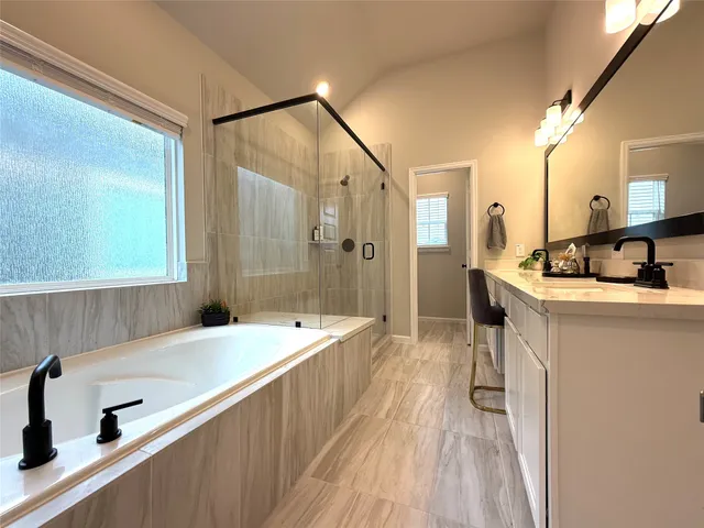 a spacious bathroom with a double vanity sink a mirror and shower