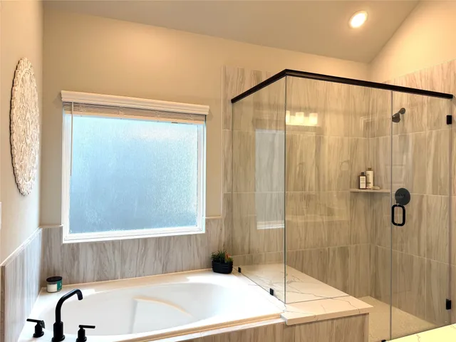 a bathroom with a bathtub and shower
