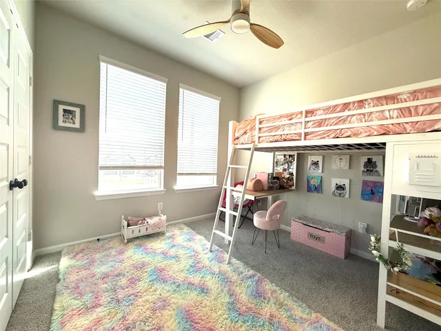 a bedroom with furniture and a large window