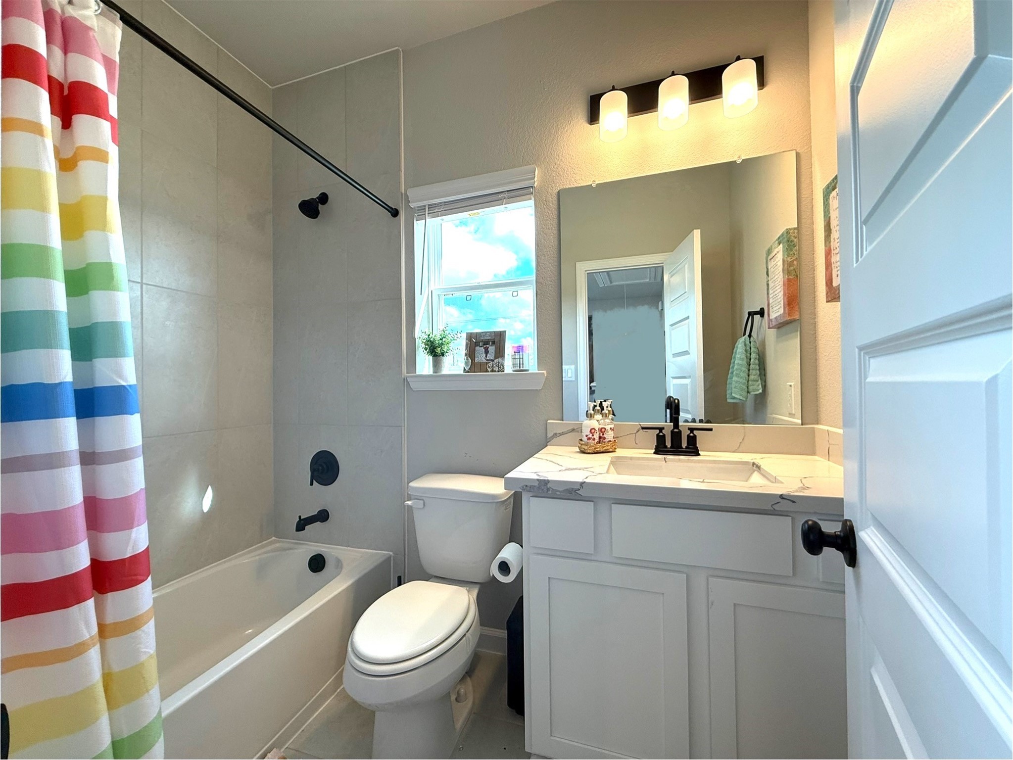 5614 Green Rise Lane Houston, TX 77091 - Photo 18 of 27 a bathroom with a sink a toilet and a mirror