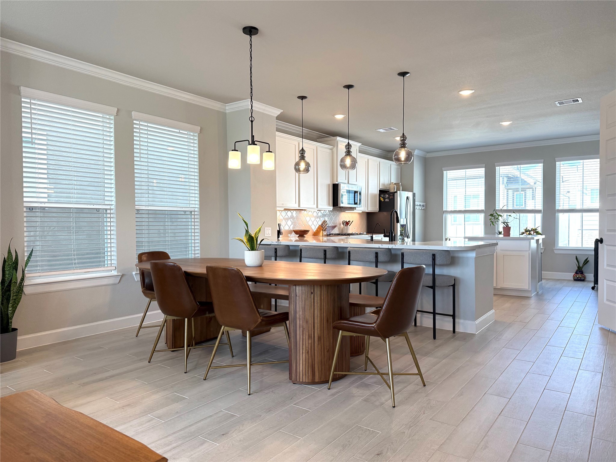 5614 Green Rise Lane Houston, TX 77091 - Photo 4 of 27 a dining room with furniture a chandelier and wooden floor