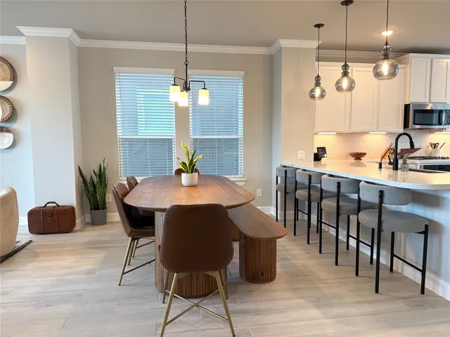 a view of a dining room with furniture window and wooden floor