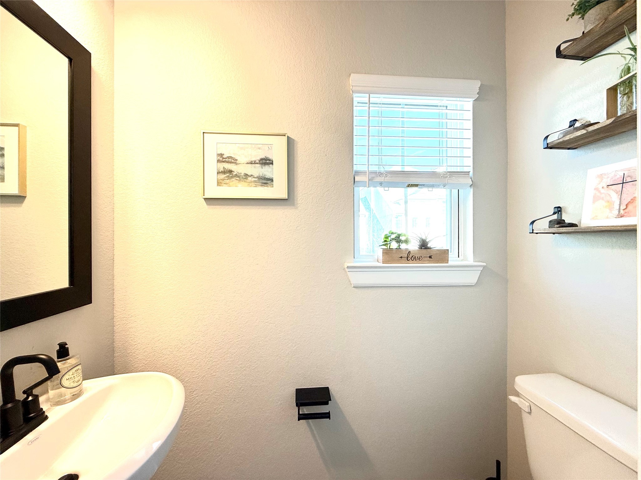 5614 Green Rise Lane Houston, TX 77091 - Photo 8 of 27 a bathroom with a toilet a sink and a mirror