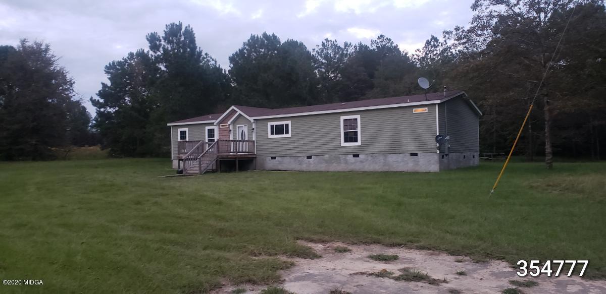 5700 Taylor Road Lizella, GA 31052 - Photo 1 of 23 a front view of a house with garden