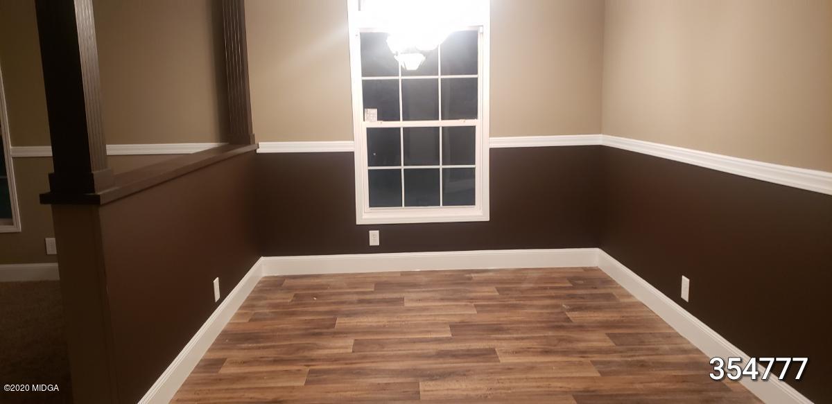 5700 Taylor Road Lizella, GA 31052 - Photo 2 of 23 a view of empty room with wooden floor and fan