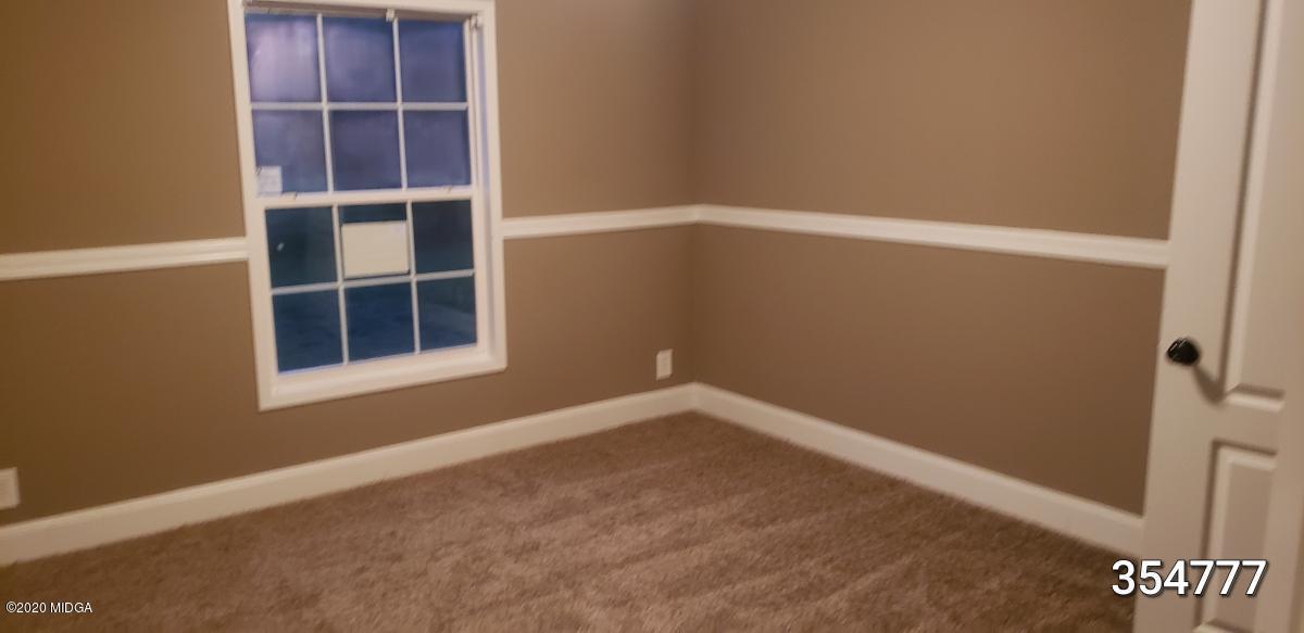 5700 Taylor Road Lizella, GA 31052 - Photo 13 of 23 a view of an empty room with a window