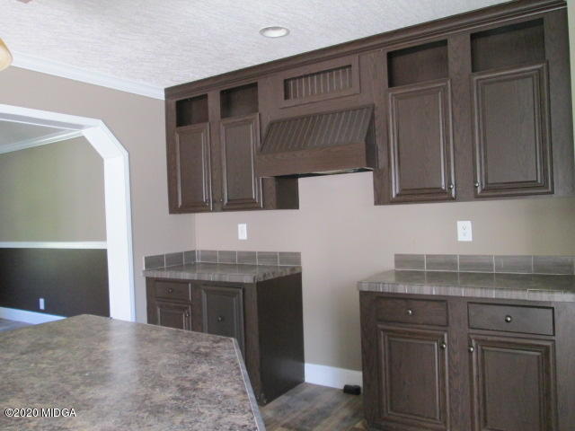 5700 Taylor Road Lizella, GA 31052 - Photo 17 of 23 a kitchen with a sink and cabinets