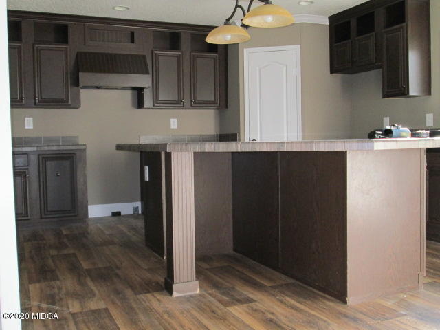 5700 Taylor Road Lizella, GA 31052 - Photo 20 of 23 a kitchen with stainless steel appliances granite countertop a refrigerator and a microwave