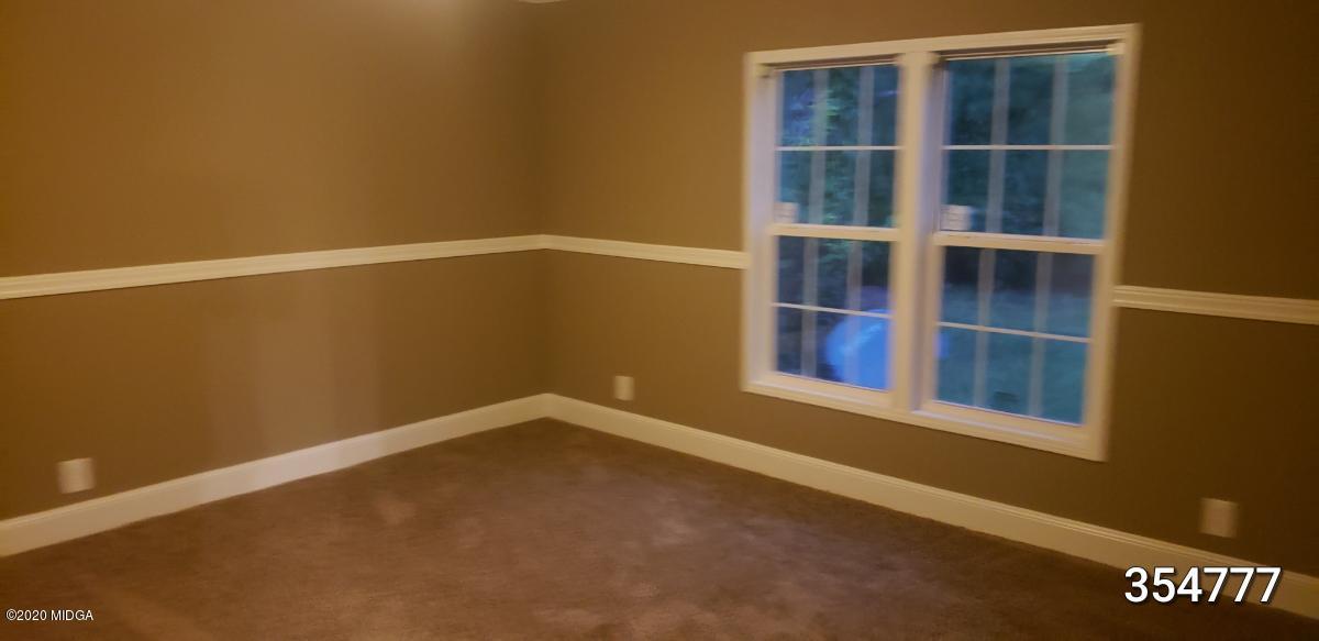 5700 Taylor Road Lizella, GA 31052 - Photo 6 of 23 a view of an empty room with a window