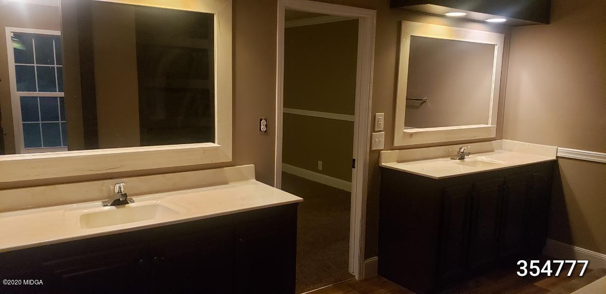 5700 Taylor Road Lizella, GA 31052 - Photo 7 of 23 a bathroom with a sink and a mirror