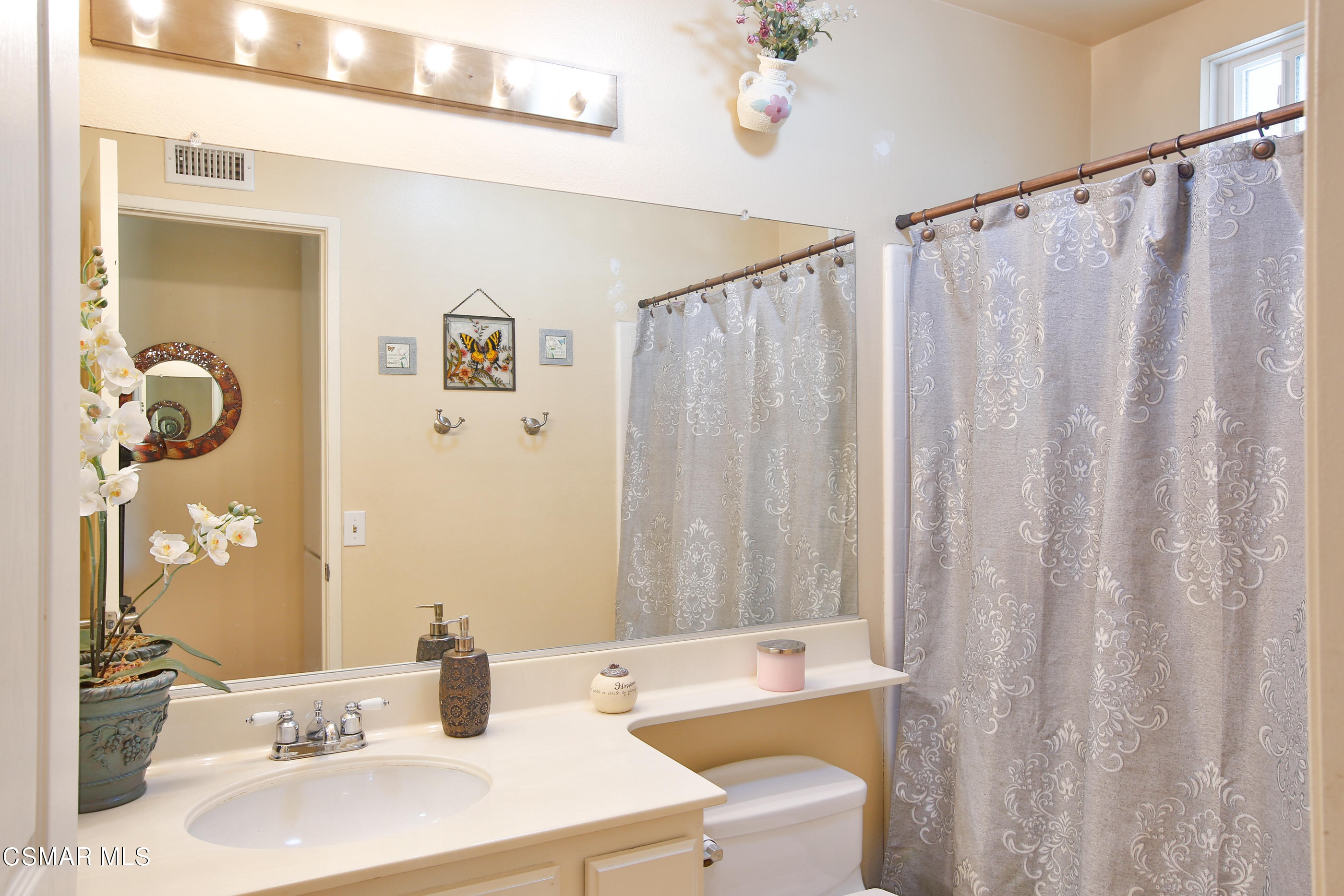 13152 East Millerton Road Moorpark, CA 93021 - Photo 25 of 36 a bathroom with a sink a mirror and a shower curtain