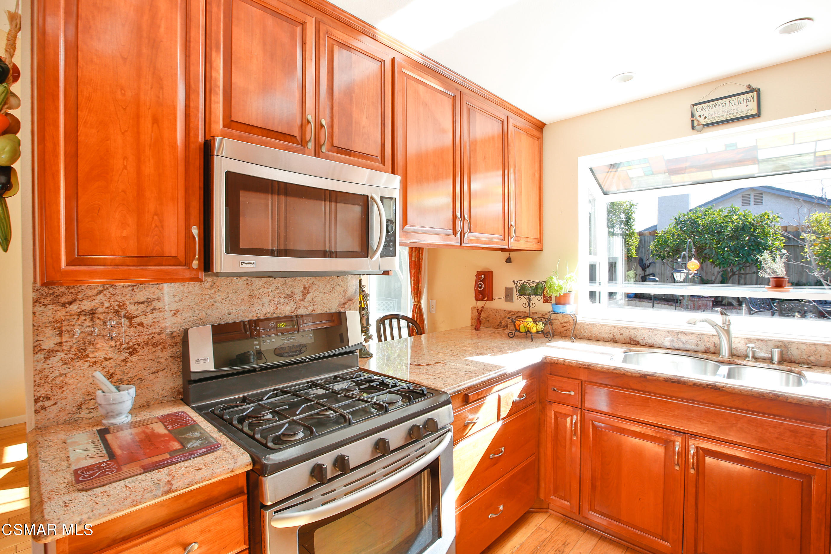 13152 East Millerton Road Moorpark, CA 93021 - Photo 10 of 36 a kitchen with granite countertop a stove a sink and a microwave