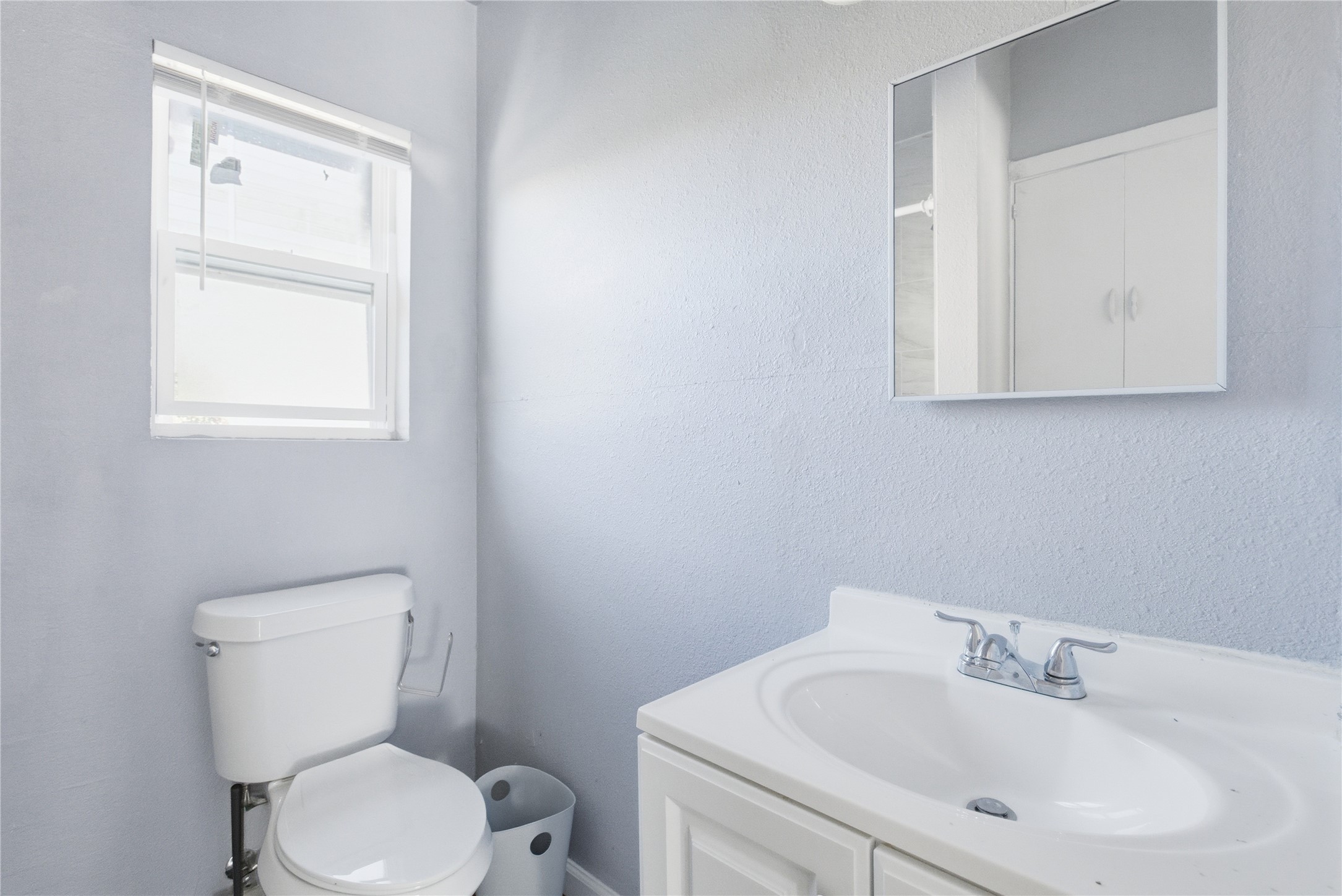 204 East 30th Street, Unit 201 Austin, TX 78705 - Photo 12 of 18 a bathroom with a toilet sink and mirror
