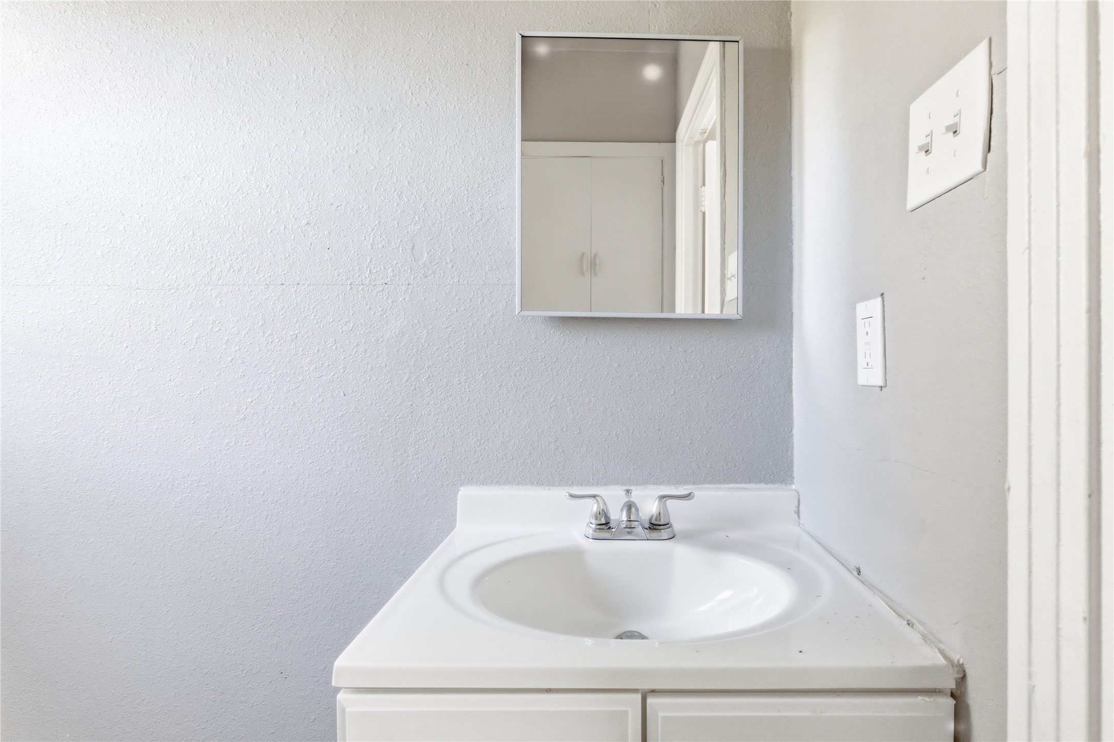 204 East 30th Street, Unit 201 Austin, TX 78705 - Photo 14 of 18 a bathroom with a sink and a mirror