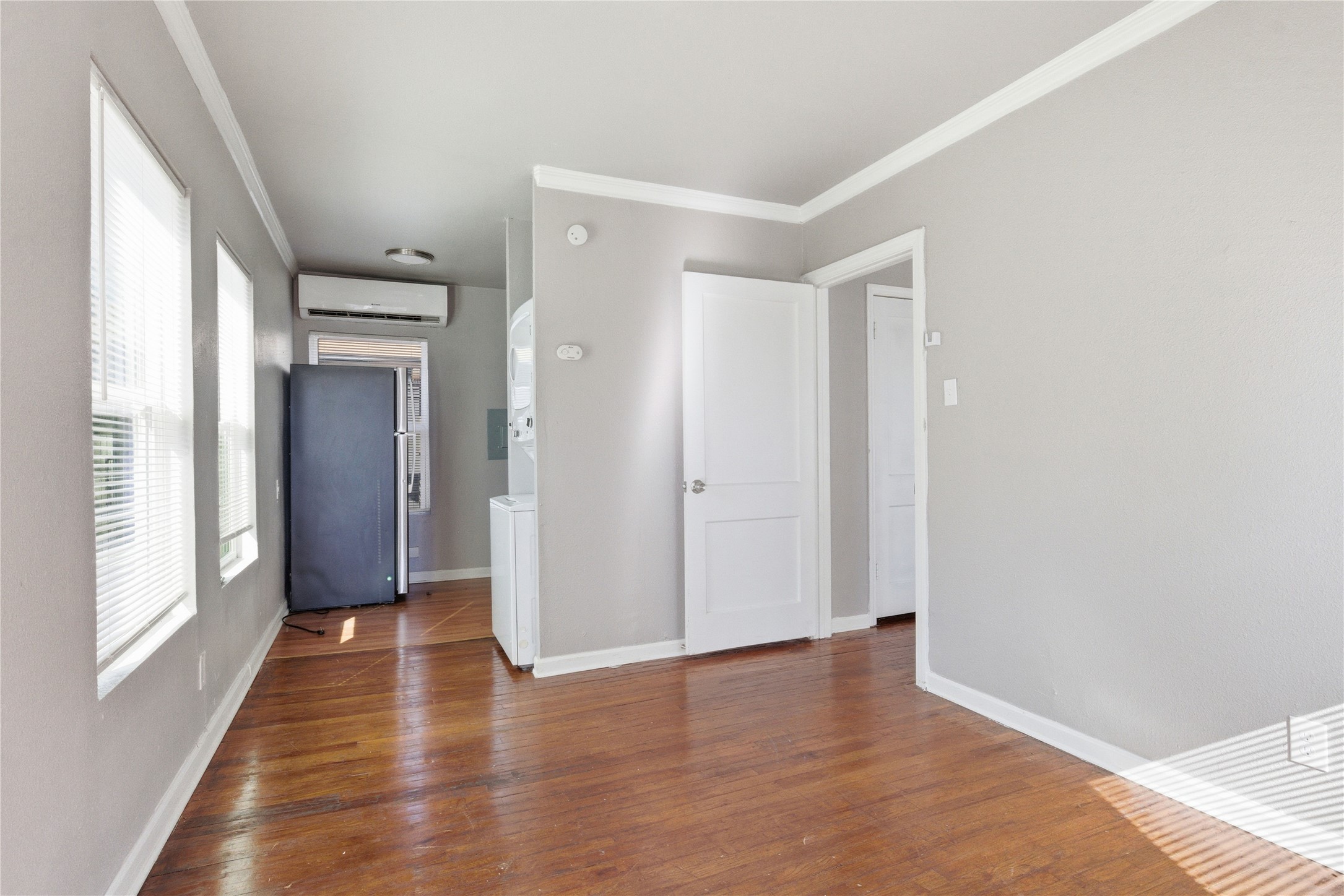 204 East 30th Street, Unit 201 Austin, TX 78705 - Photo 5 of 18 a view of a hallway with wooden floor and windows