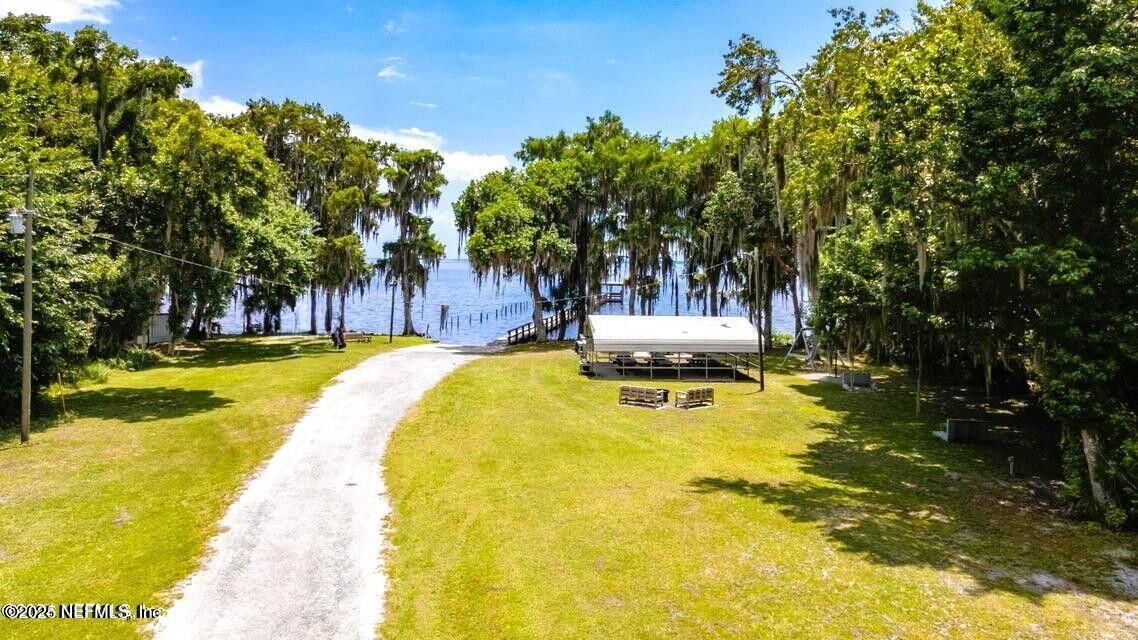 212 Atkins Road Georgetown, FL 32139 - Photo 18 of 20 a swimming pool with outdoor seating and yard