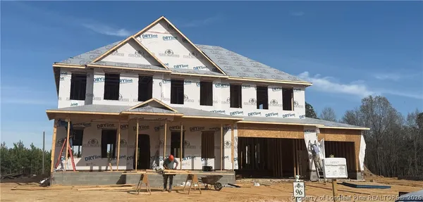 a front view of a residential apartment building with a yard