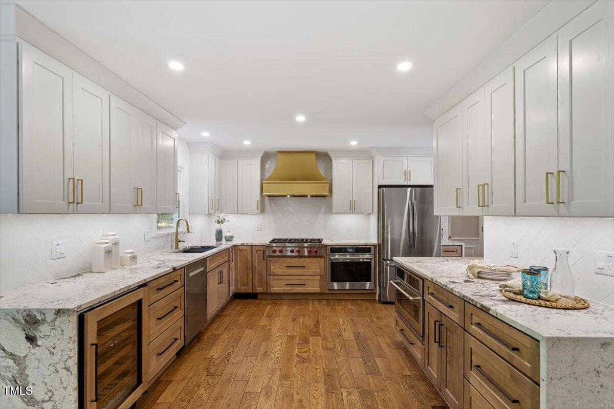 7209 Halstead Lane Raleigh, NC 27613 - Photo 26 of 64 a large kitchen with stainless steel appliances granite countertop a stove sink and cabinets