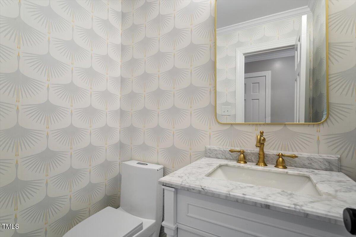 7209 Halstead Lane Raleigh, NC 27613 - Photo 37 of 64 a bathroom with a granite countertop sink a toilet and mirror