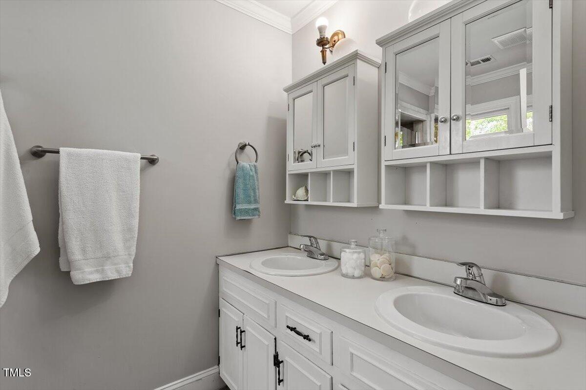 7209 Halstead Lane Raleigh, NC 27613 - Photo 41 of 64 a bathroom with double vanity and a mirror