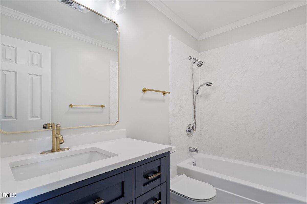 7209 Halstead Lane Raleigh, NC 27613 - Photo 44 of 64 a bathroom with a sink a toilet and shower