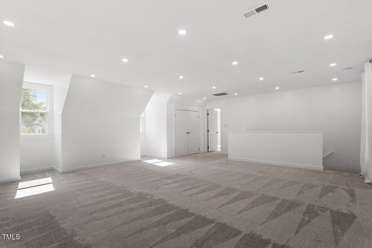 7209 Halstead Lane Raleigh, NC 27613 - Photo 48 of 64 a view of an empty room with wooden floor and a window