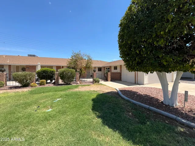 a view of a house with backyard and sitting area