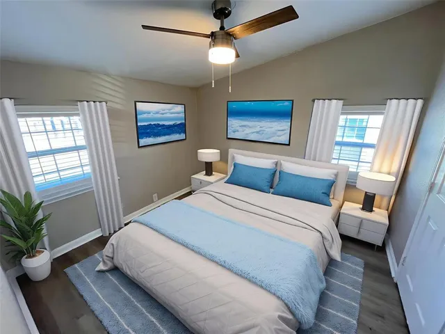 a bedroom with a large bed and a window