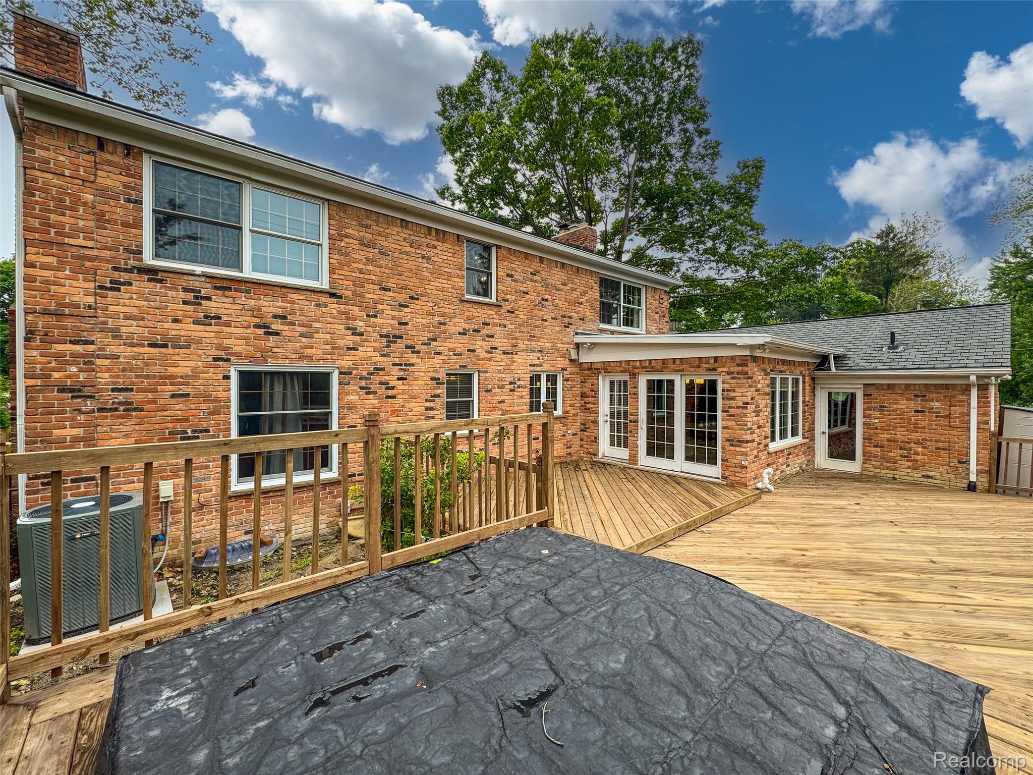 100 Overhill Road Bloomfield Hills, MI 48301 - Photo 54 of 55 Rear view of house with a chimney, a deck, and brick siding