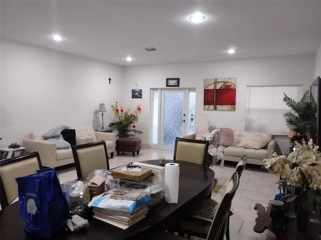 a living room with furniture a rug and a flat screen tv
