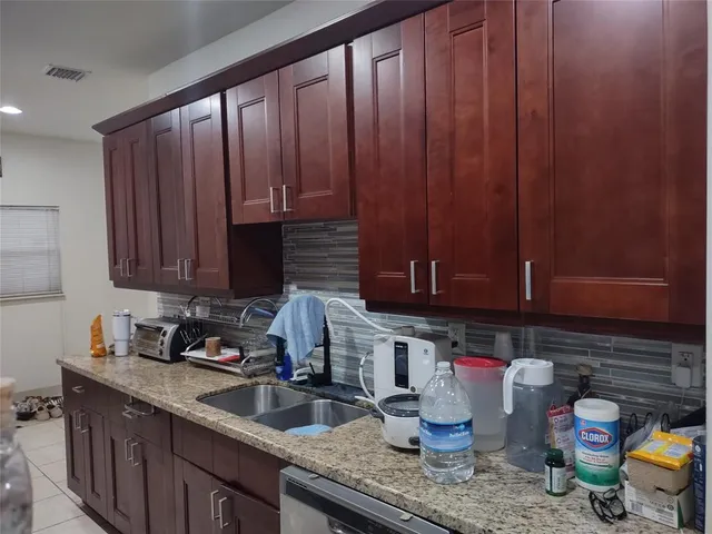 a kitchen with stainless steel appliances granite countertop a sink stove and cabinets