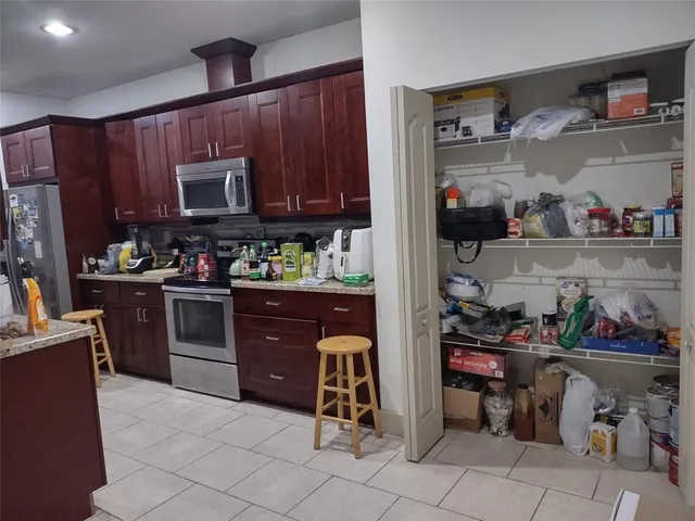 a kitchen with granite countertop wooden cabinets and sink
