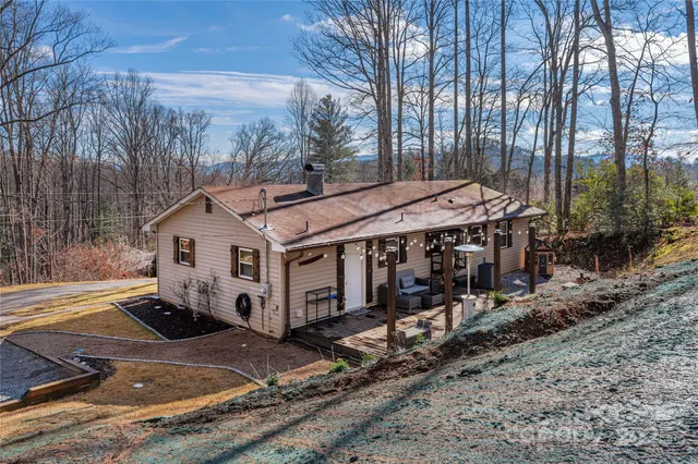 a view of a house with a yard wooden fence and a wooden fence
