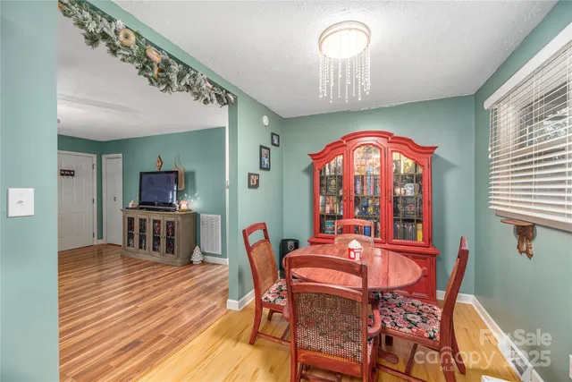 a view of a dining room with furniture and chandelier