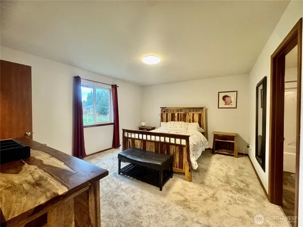 a bedroom with furniture and wooden floor