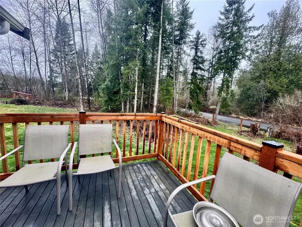 a backyard of a house with lots of green space and plants