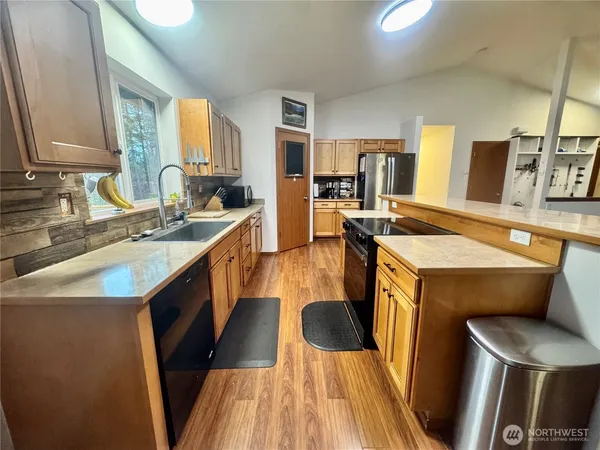 a kitchen with a sink stove and wooden cabinets